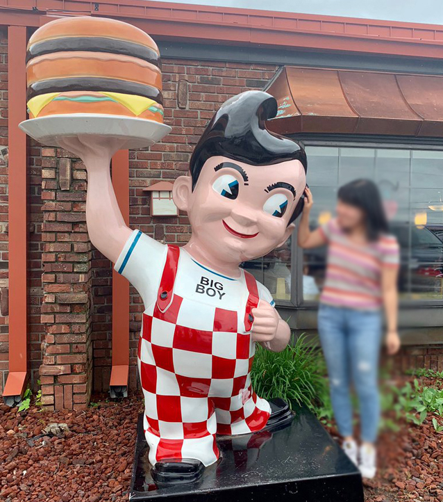 Fiberglass sculpture of big boy holding hamburger