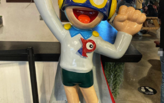A masked Nobita fiberglass sculpture adorn a cartoon cinema shop