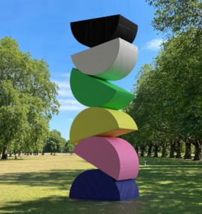 Colorful fan shapes stacked high fiberglass sculpture lawn simple artistic embellishment
