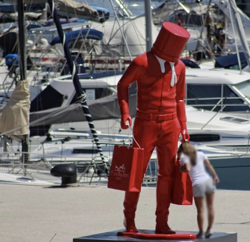 Red man with a white paint bucket on his head fiberglass sculpture