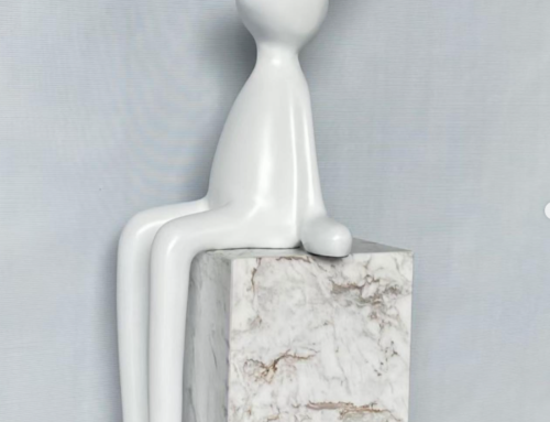 The small White sitting fiberglass rabbit sculpture embellishes the pure indoor environment